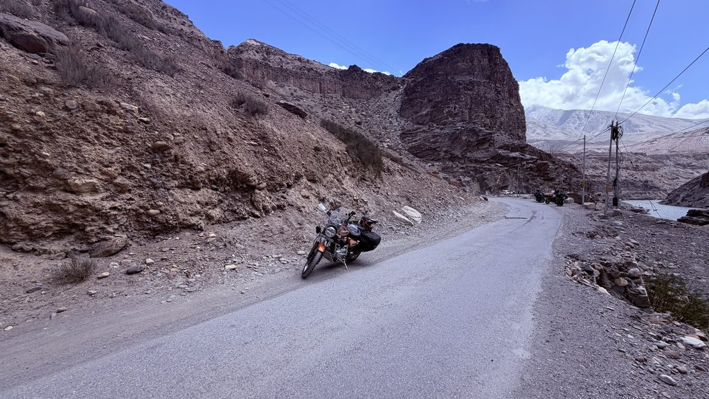 Riders fixing puncture on remote Spiti mountain road