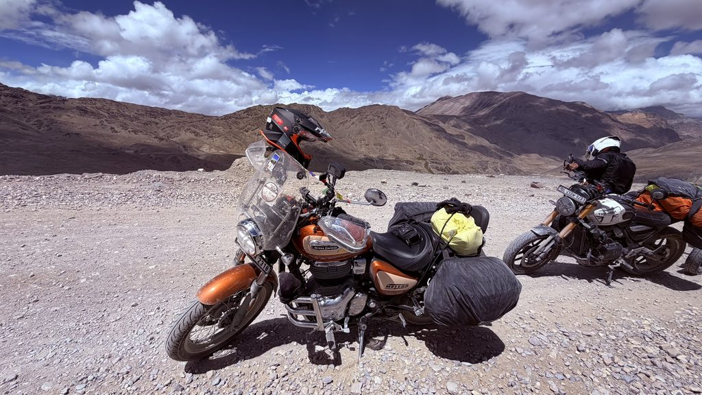 Motorcycle ride on rocky off-road trail in Spiti Valley with Royal Enfield and adventure bike