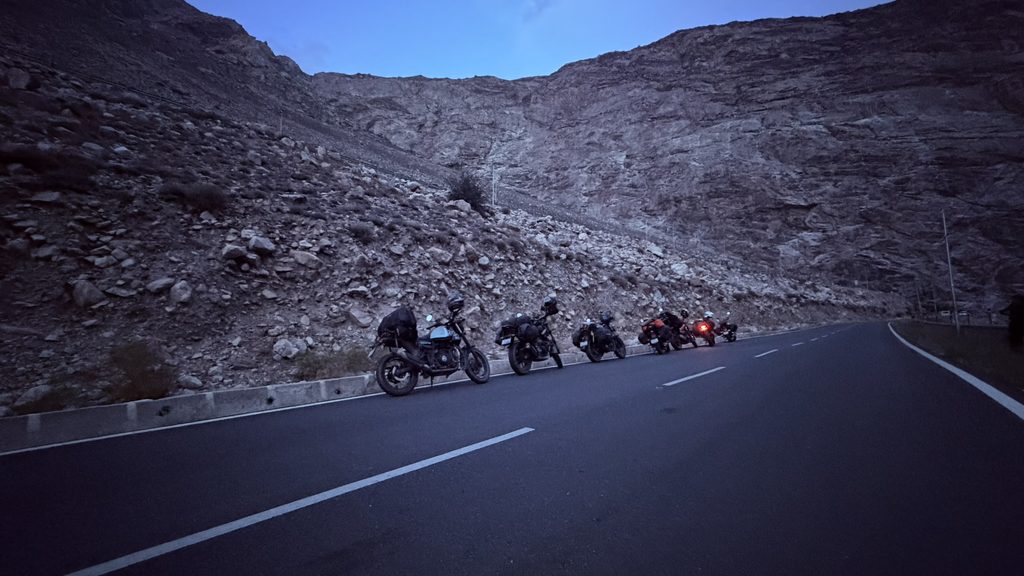 Riders stopping in silent mountain valley with strong winds