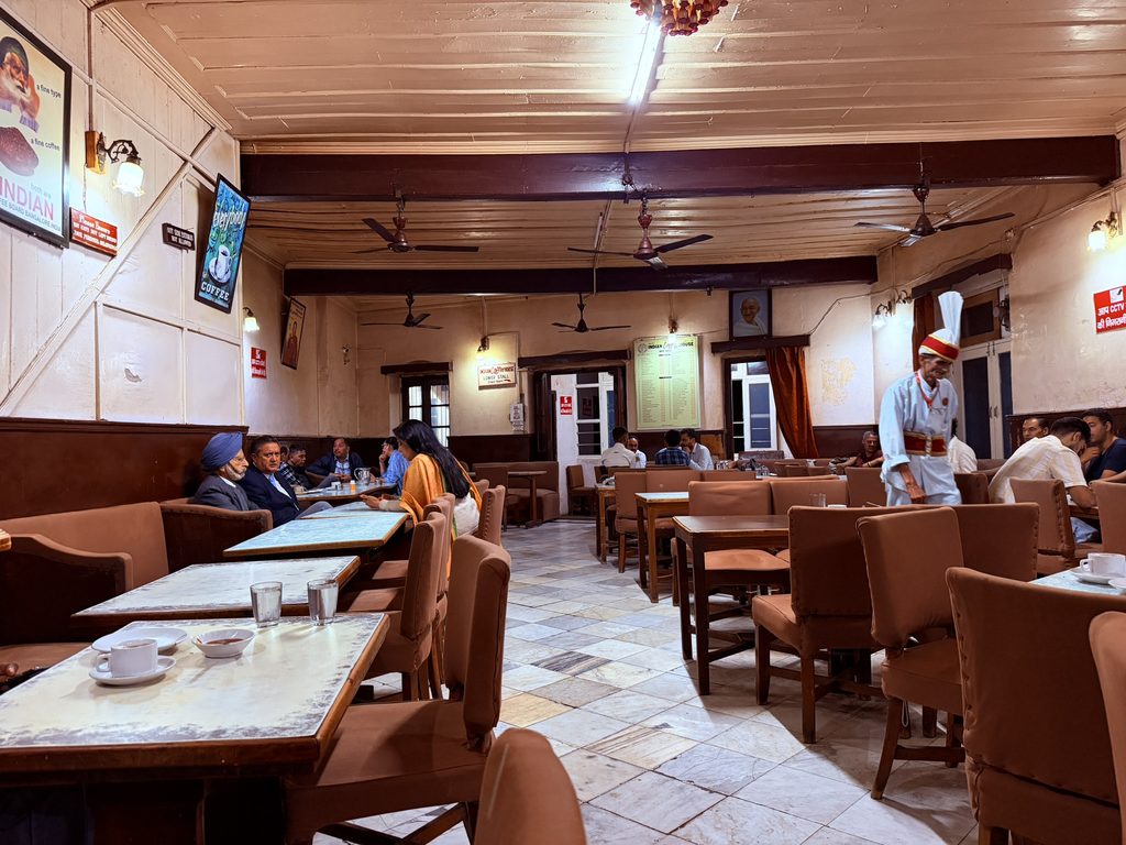 Old-fashioned interior of Indian Coffee House in Shimla with traditional furniture.