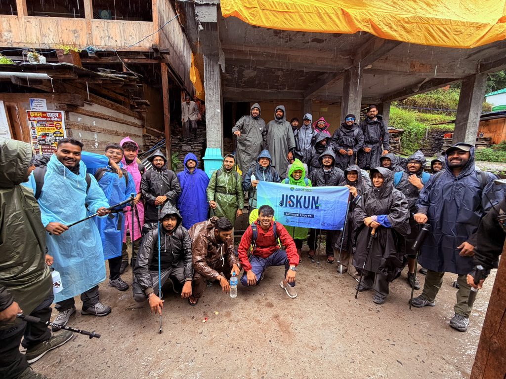 Group of Rupin Pass trekkers with backpacks posing together at the start of the mountain trek