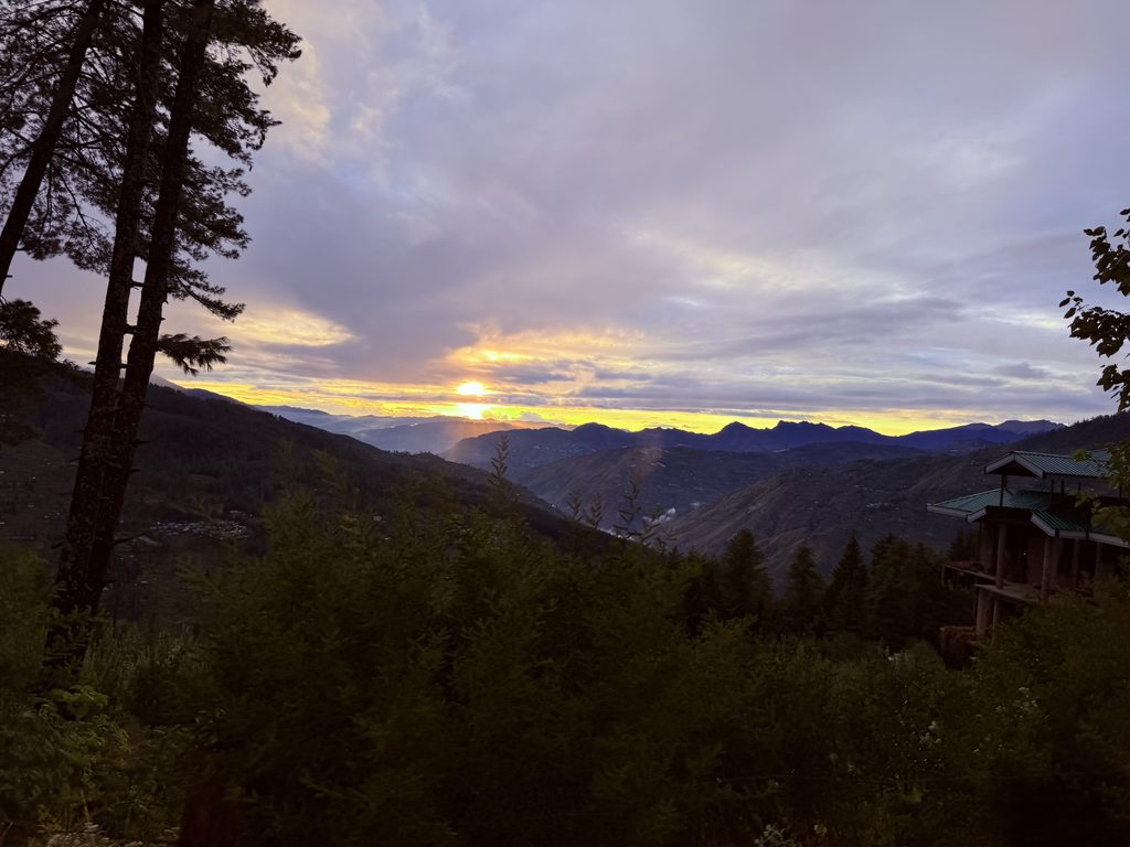 Golden sunset over layered Himalayan mountain ridges
